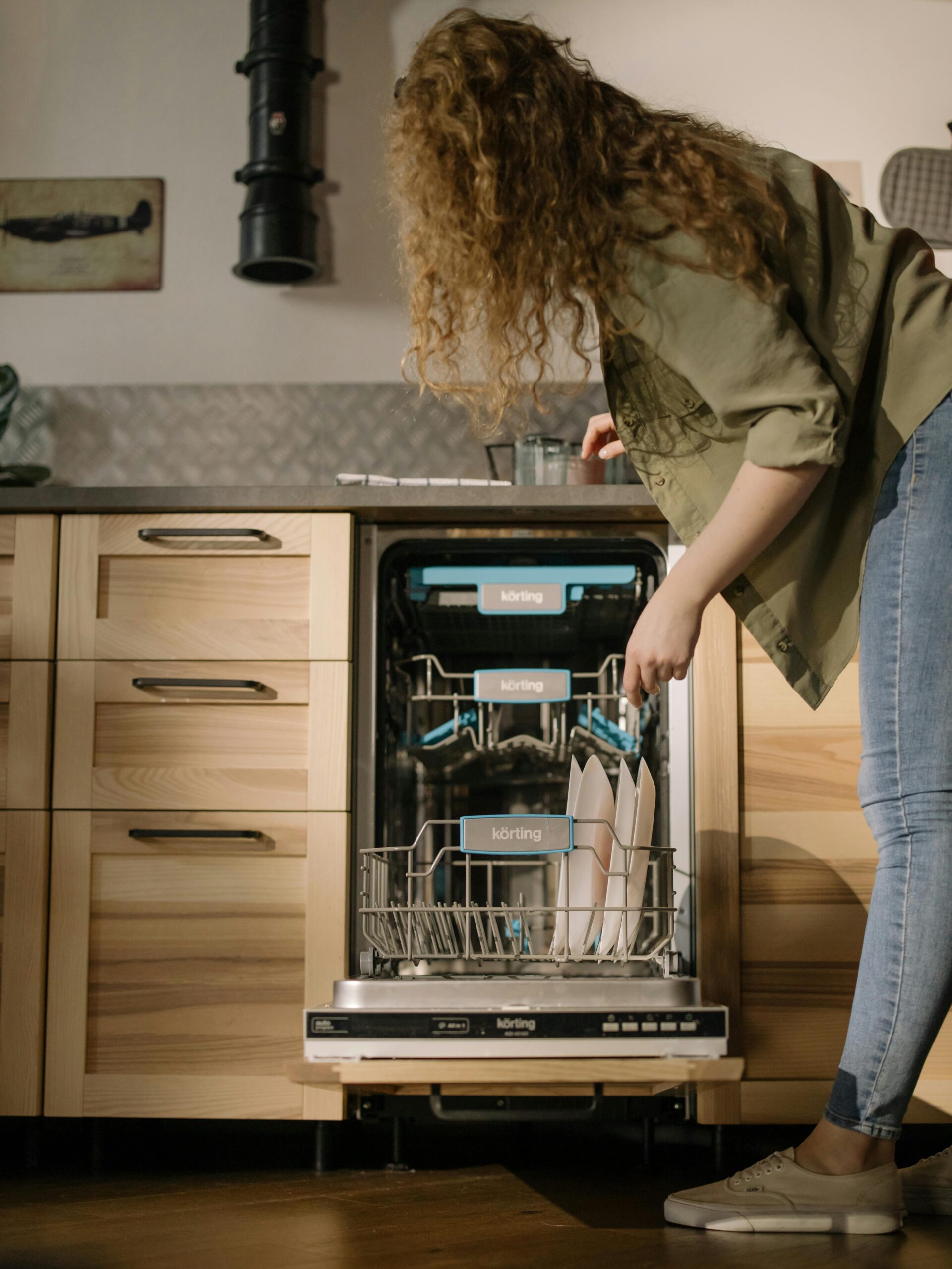 Evening Reset Routine- pictures shows a woman loading a dishwasher